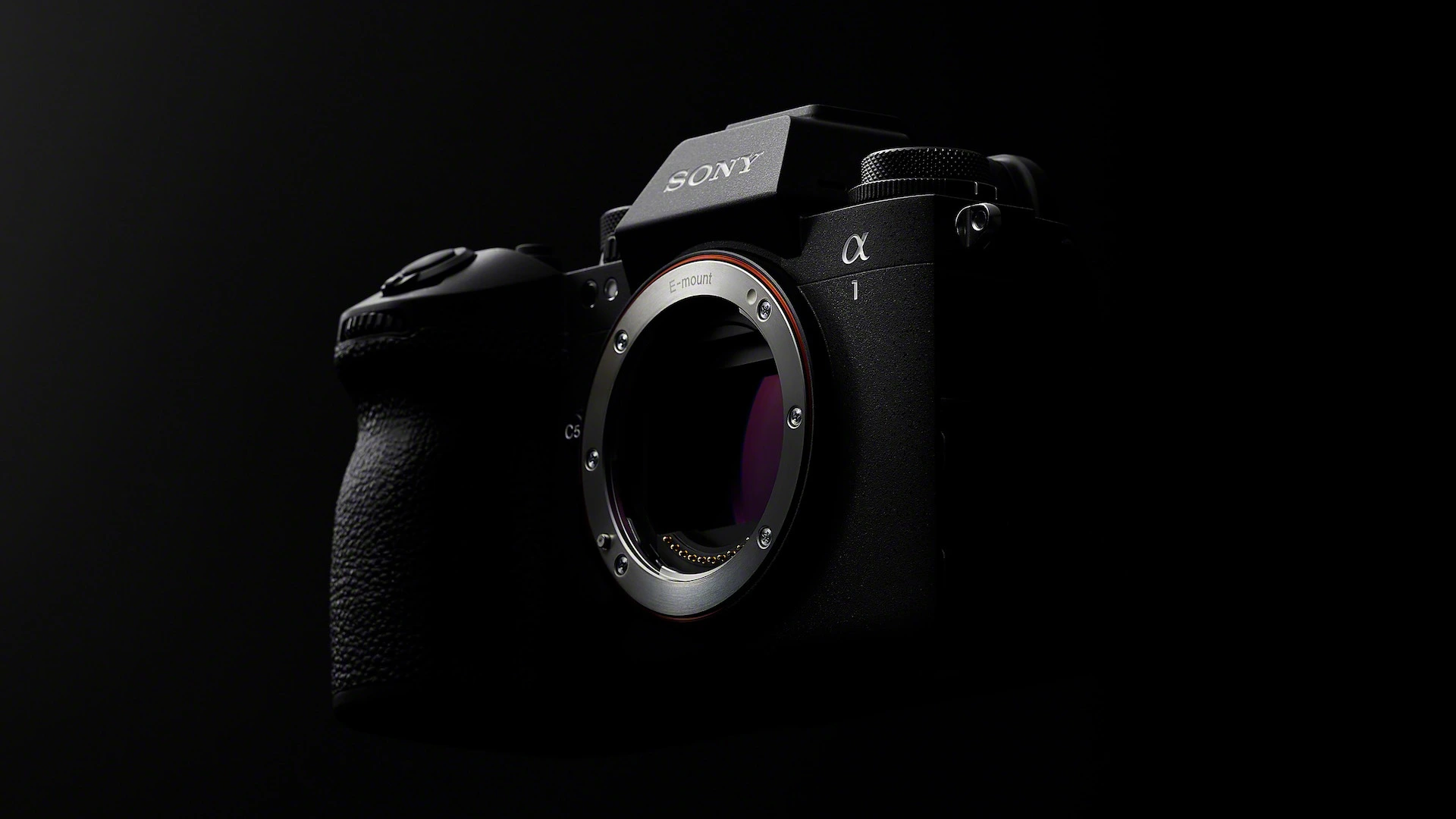 A Sony mirrorless camera body without a lens on a dark background.